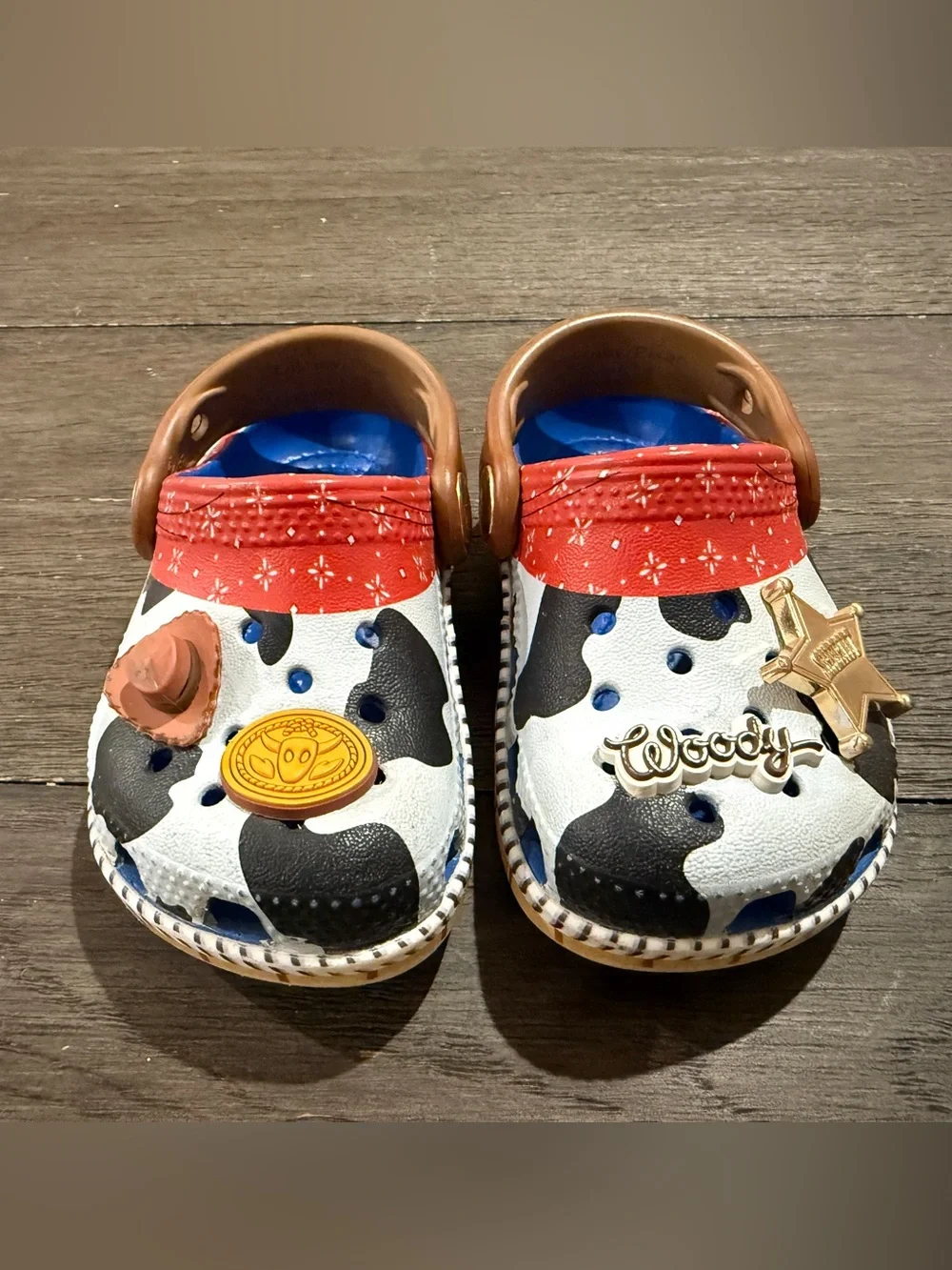 CROCS Kids Cow-Print Clogs with Red Strap and Blue Lining Toy Story Woody